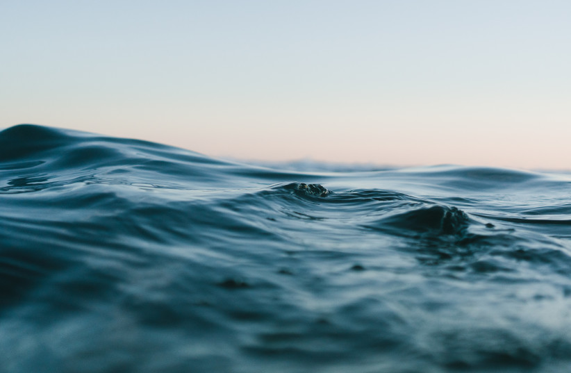 Dark blue waves on the surface of the open ocean. (photo credit: PEXELS)