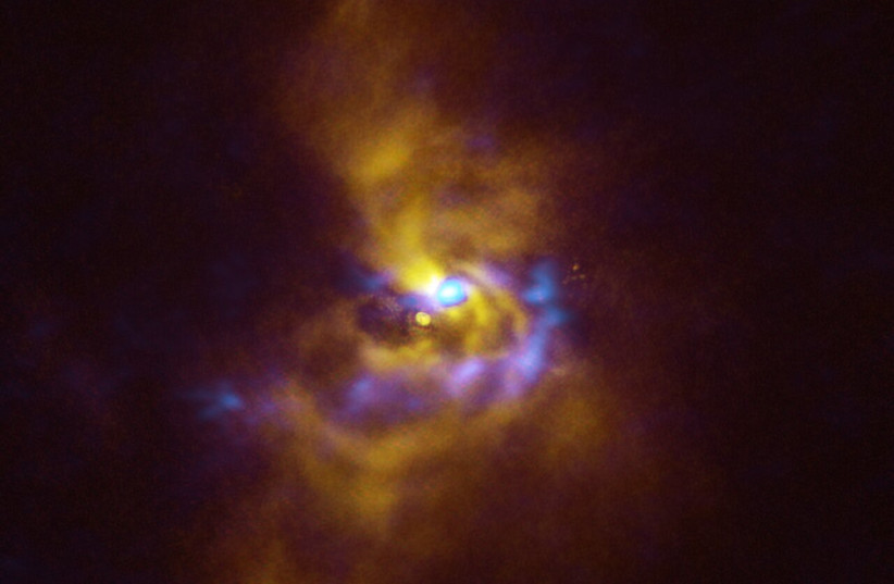  At the center of this image is the young star V960 Mon. Surrounding it are spiral arms of materials that are collapsing to form planets. (photo credit: ESO/ALMA (ESO/NAOJ/NRAO)/Weber et al.)