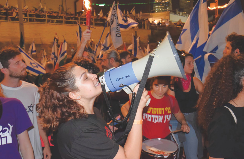  THE WRITER is among those blocking Ayalon Highway at a protest last month, after having addressed a demonstration from the main stage on Kaplan Street in Tel Aviv.  (photo credit: Gilad Bashan)