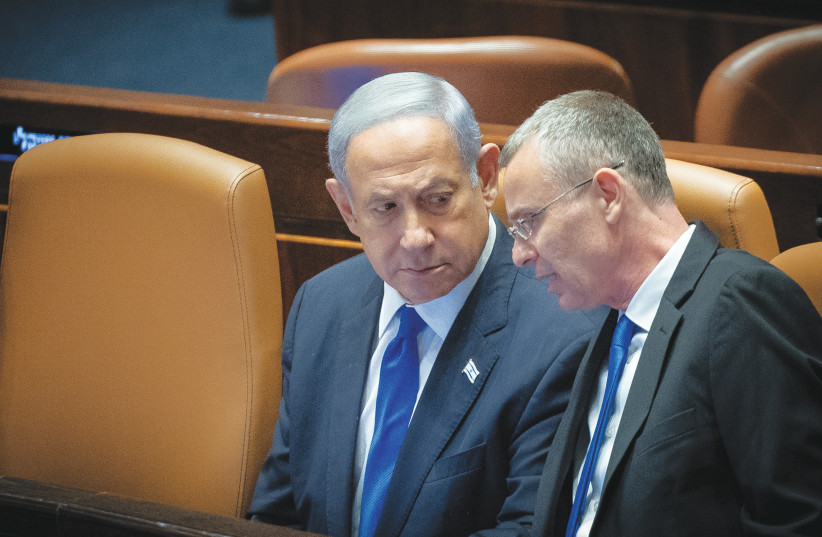  JUSTICE MINISTER Yariv Levin speaks with Prime Minister Benjamin Netanyahu during the voting in the Knesset plenum on Monday. (photo credit: YONATAN SINDEL/FLASH90)