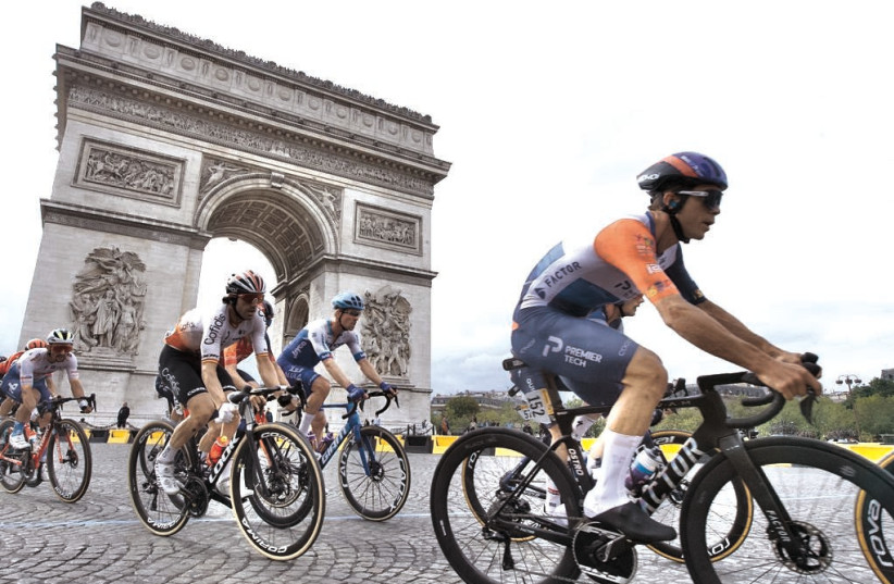   Israel – Premier TECH riders pass the Arc de Triomphe on the Champs-Élysées in Paris during the final stage of the 2023 Tour de France. (photo credit: NOA ARNON)