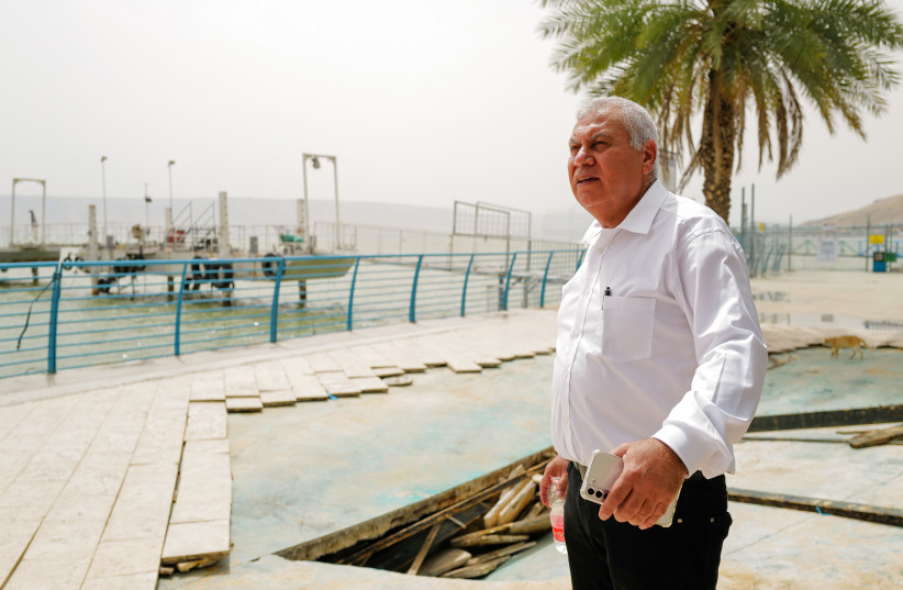  Boaz Yosef looks at the damage caused to the promenade in Tiberias as a result of strong winds, May 15, 2022 (photo credit: MICHAEL GILADI/FLASH90)