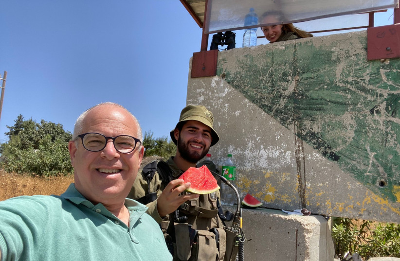  HAVING BEEN unable to serve in the IDF, the writer serves in a different way – dishing out watermelon to soldiers on active duty. (photo credit: Jonathan Feldstein)