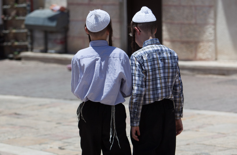  CHILDREN STROLL in Jerusalem’s ultra-Orthodox Mea She’arim neighborhood.  (photo credit: YONATAN SINDEL/POOL)