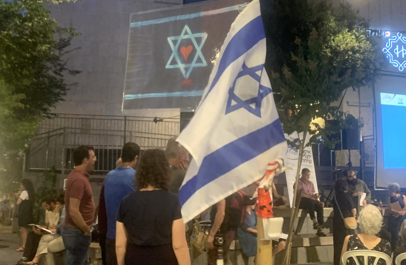  Dina, who asked that we not use her last name, waved two Israeli flags, one being her own design, at Zion Square on Wednesday night to commemorate the eve of Tisha Be’Av (photo credit: ARIEL SHEINBERG)