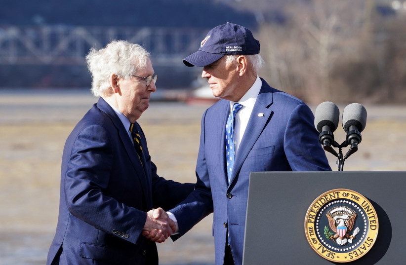  U.S. President Joe Biden shakes hands with U.S. Senate Republican Leader Mitch McConnell (R-KY) during an event to tout the new Brent Spence Bridge over the Ohio River between Covington, Kentucky and Cincinnati, Ohio near the bridge in Covington, Kentucky, U.S., January 4, 2023.  (photo credit: REUTERS)