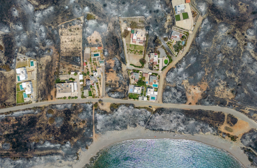  An aerial view of houses among burned land, as a wildfire burns on the island of Rhodes, Greece July 27, 2023. (photo credit: NICOLAS ECONOMOU/REUTERS)