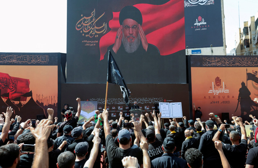  Lebanon's Hezbollah leader Sayyed Hassan Nasrallah addresses his supporters through a screen during a religious ceremony to mark Ashura in Beirut's southern suburbs, Lebanon July 29, 2023 (photo credit: REUTERS/AZIZ TAHER)