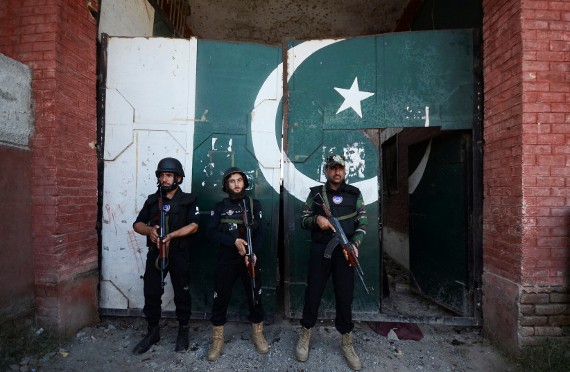  Police officers stand guard at the entrance of a building, after a suicide blast in Bara, on the outskirts of Peshawar, Pakistan July 20, 2023. (photo credit: REUTERS/STRINGER)