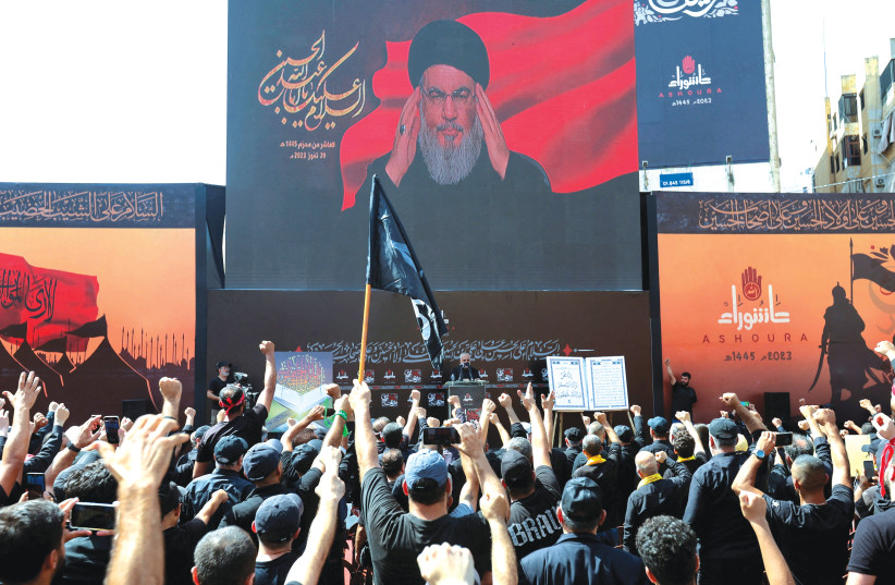  HEZBOLLAH LEADER Hassan Nasrallah addresses supporters via video at a ceremony to mark Ashura Day, in Beirut’s southern suburbs, on Saturday.  (photo credit: AZIZ TAHER/REUTERS)