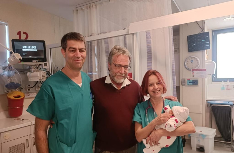  In the photo from left: Dr. Shai Porat; Dr. Dan Arbel; and Noa Ofek-Shloma’i, with the baby in her arms. (photo credit: Hadassah-University Medical Center)