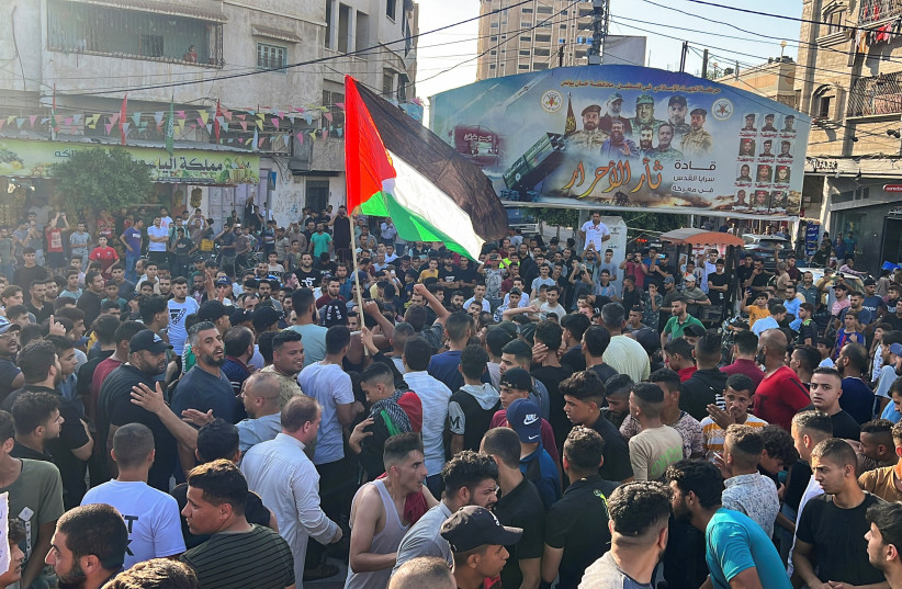  Palestinians protest calling for an end to internal divisions and resolving longstanding power crisis, in Khan Yunis in the southern Gaza Strip July 30, 2023. (photo credit: IBRAHEEM ABU MUSTAFA/REUTERS)