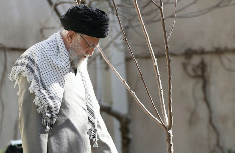  IRAN’S SUPREME LEADER Ali Khamenei waters a sapling during an Arbor Day ceremony in Tehran, in March. (photo credit: Office of the Iranian Supreme Leader/West Asia News Agency/Reuters)