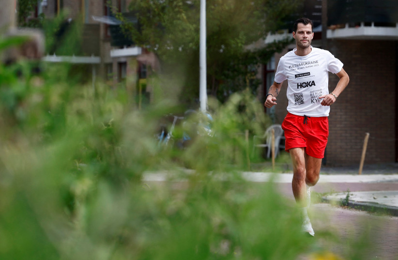  Dutch runner Boas Kragtwijk runs after an interview with Reuters in Amsterdam (photo credit: REUTERS)