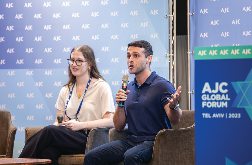  THE WRITER addresses the American Jewish Committee Global Forum in Tel Aviv, in June, as co-researcher Omer Noam sits alongside him. (photo credit: Local Eyes Israel Tour Photography)