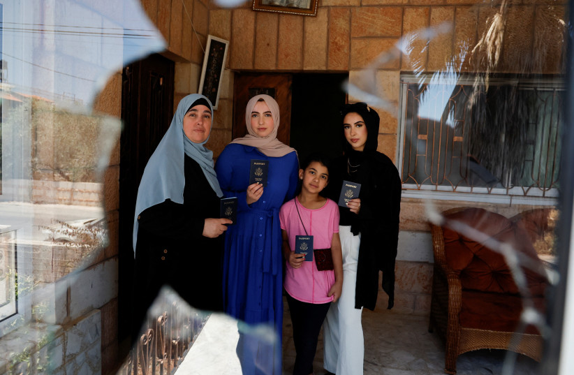  Palestinian family hold their American passports in their house that was torched June 23, 2023. (photo credit: REUTERS)