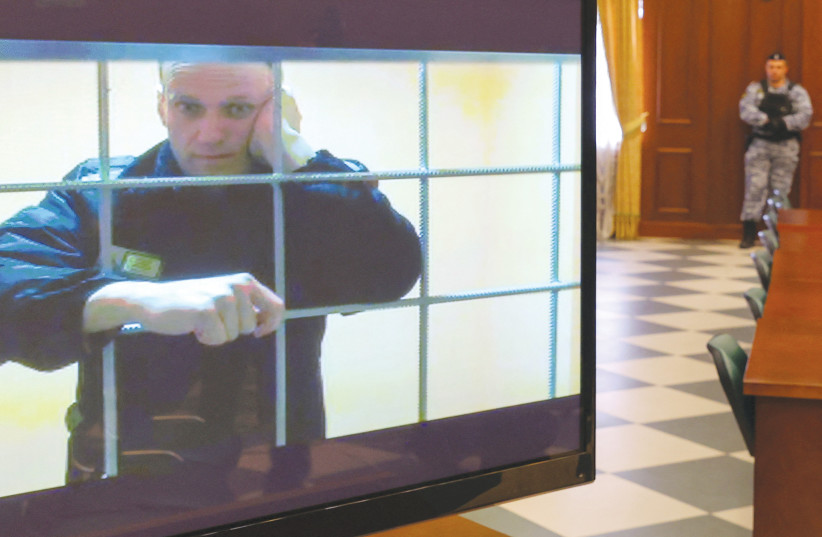  RUSSIAN OPPOSITION leader Alexei Navalny is seen via a video link from a corrective penal colony during a court hearing to consider an appeal against his prison sentence, in Moscow, last year. (photo credit: EVGENIA NOVOZHENINA/REUTERS)