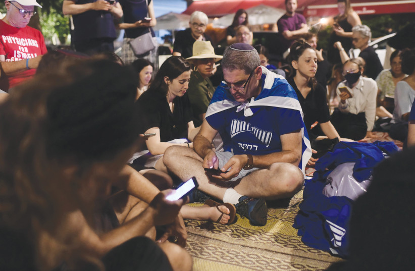  RELIGIOUS AND secular Jews gather on Tisha Be’av, last week, outside of Independence Hall in Tel Aviv, to hear the reading of the Book of Eicha. (photo credit: TOMER NEUBERG/FLASH90)