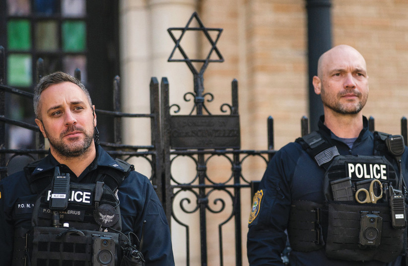  NEW JERSEY police officers stand guard in front of the United Synagogue of Hoboken in New Jersey, last year. (photo credit: Eduardo Munoz/Reuters)