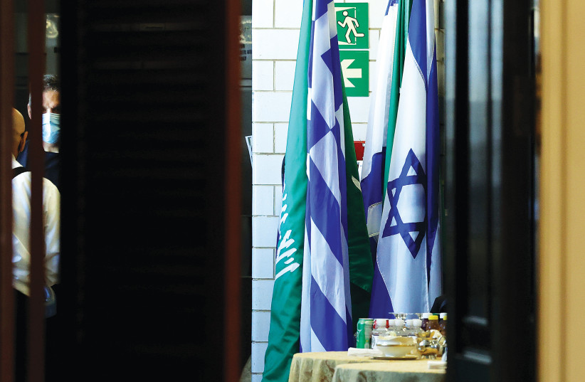  FLAGS OF Saudi Arabia and Israel stand together in a kitchen staging area as US Secretary of State Antony Blinken holds meetings at the State Department in Washington, in October 2021. (photo credit: JONATHAN ERNST/POOL/REUTERS)
