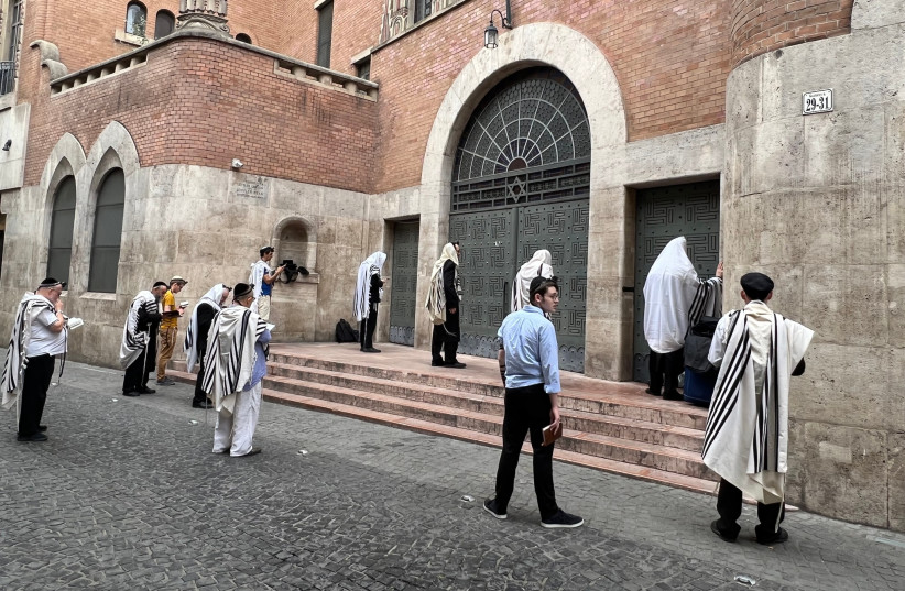  Worshippers hold morning services outside the locked doors of the Kazinczy Street Synagogue in Budapest, Hungary, July 21, 2023 (photo credit: David Kelsey via JTA)