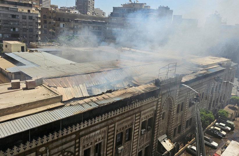  Smoke rises as Egyptian firefighters extinguish a fire that broke out in the historic neo-Islamic ministry in central Cairo, Egypt, August 5, 2023. (photo credit: REUTERS/Patrick Werr)