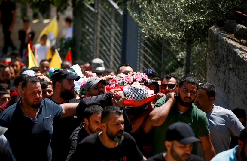  Palestinians carry the body of 19-year-old Palestinian Qusai Jamal Maatan, who were killed from a gunshot during clashes with Jewish settlers, in the West Bank village of Burka, August 5, 2023. (photo credit: FLASH90)