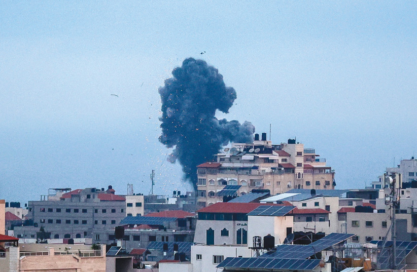  SMOKE RISES after an Israeli airstrike in Gaza City, earlier this year. Israel’s rapid pinpoint attack capability to fight urban-based and civilian-embedded terror is transforming the strategic impact of air power, say the writers.  (photo credit: ATIA MOHAMMED/FLASH90)