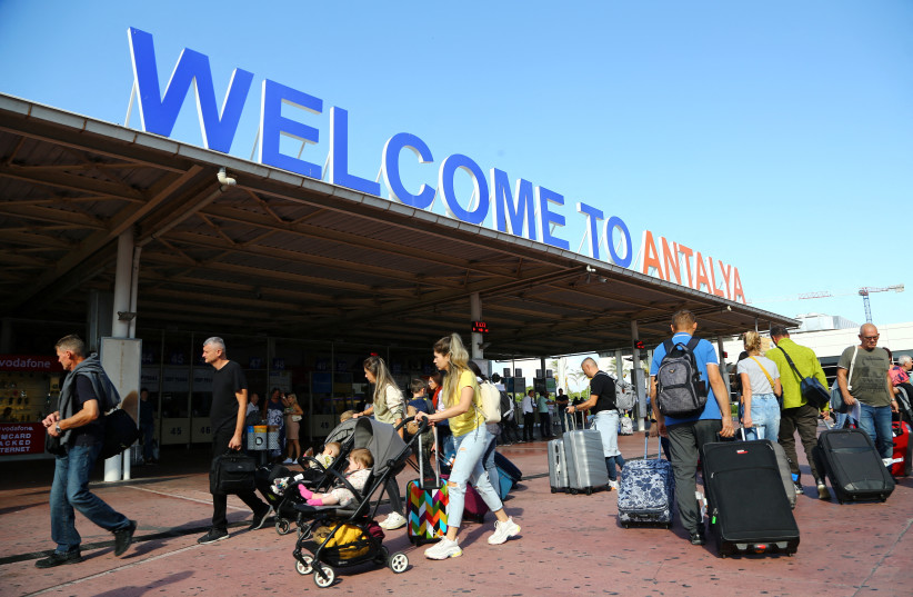  Tourists, coming mainly from Russia, leave from the arrival terminal at Antalya International Airport in the Mediterranean resort city of Antalya, Turkey September 22, 2022 (photo credit: REUTERS/KAAN SOYTURK )