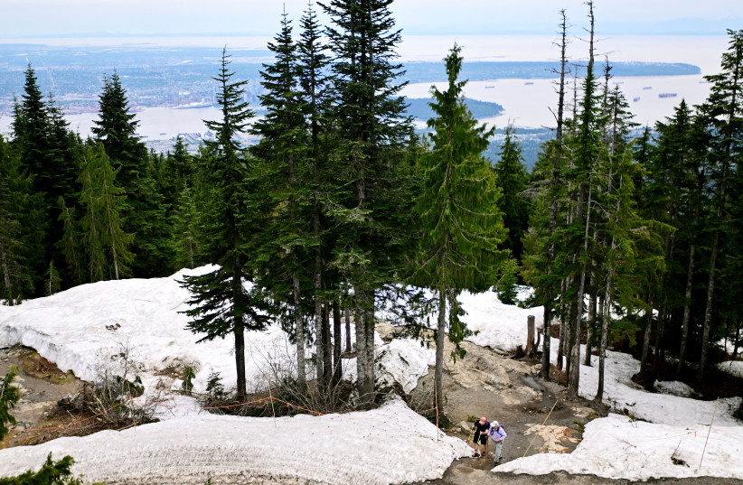  Hikers reach the top of the Grouse Grind at Grouse Mountain in North Vancouver, British Columbia, Canada June 1, 2022 (photo credit: REUTERS/JENNIFER GAUTHIER)