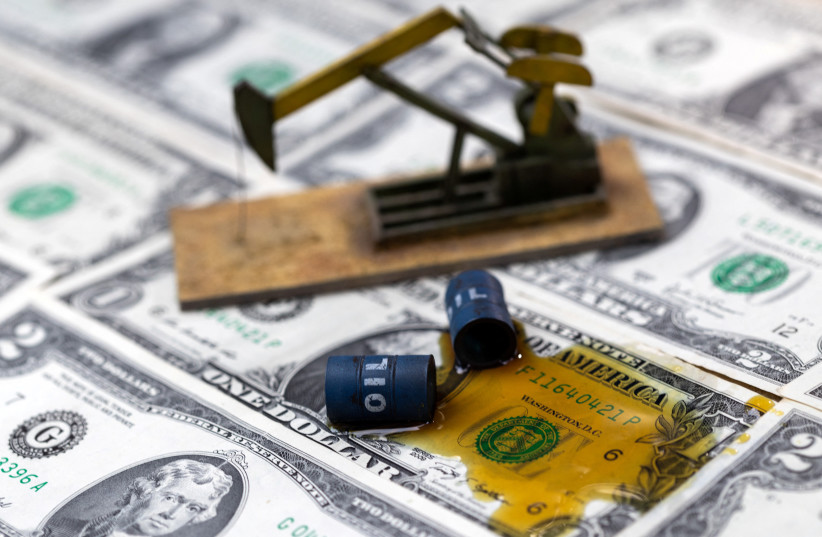  Oil, miniatures of oil barrels, oil pump jack and U.S. dollar banknote are seen in this illustration taken, June 6, 2023. (photo credit: DADO RUVIC/REUTERS)