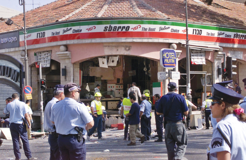  SECURITY AND rescue personnel respond at the scene of the suicide attack at the Sbarro restaurant in midtown Jerusalem in August 2001.  (photo credit: REUTERS)