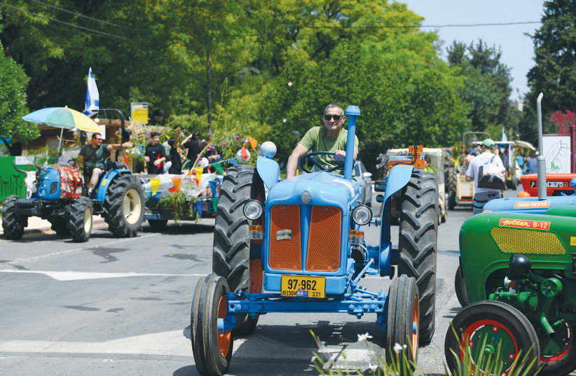  SHAVUOT IS celebrated at Moshav Ramot Naftali, in the north, this past May. Festivals like Passover, Sukkot, and Shavuot are linked to agricultural cycles. (photo credit: AYAL MARGOLIN/FLASH90)