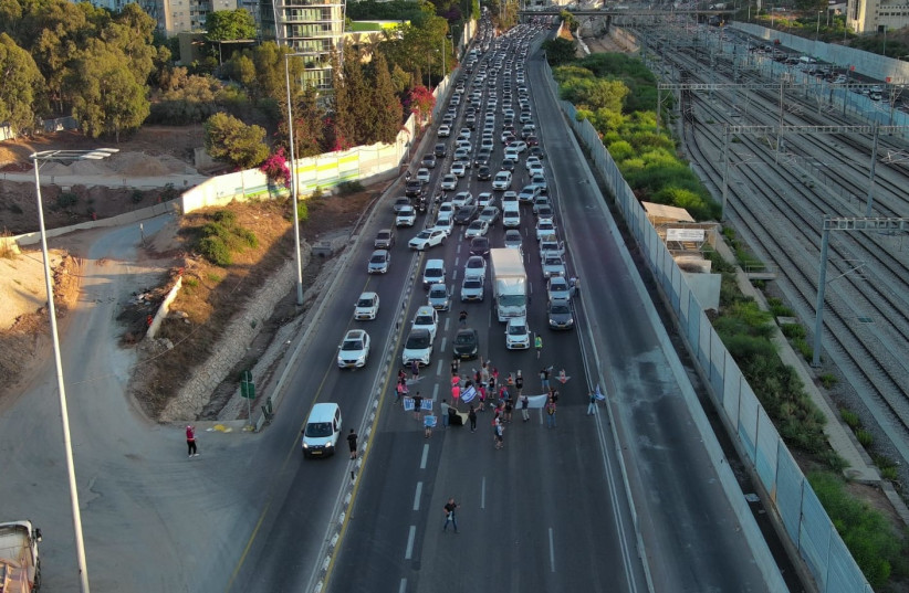  Protesters block the Ayalon highway. August 10, 2023 (photo credit: TALI MELAMED)