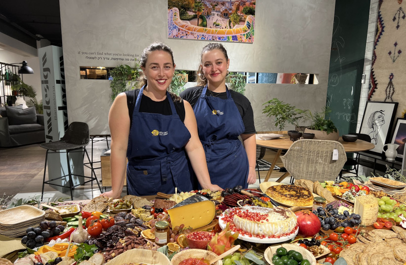  ALIYA FASTMAN (left) and Shaendl Davis stand at a grazing table in their cooking studio. (photo credit: Citrus & Salt)