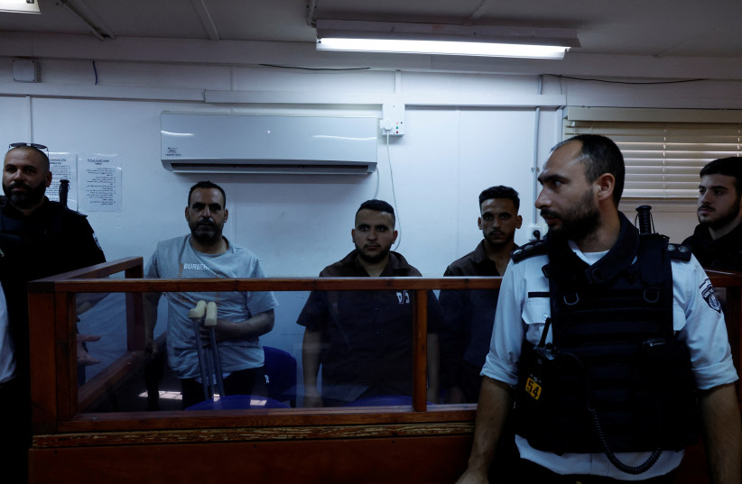  Four detained Palestinians, a father and three of his sons, are seen during their military court hearing, August 10, 2023 (photo credit: REUTERS)