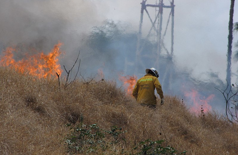  A brush fire in Hawaii. (photo credit: Wikimedia Commons)