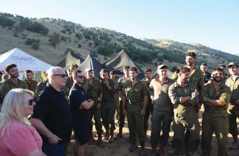  PRIME MINISTER Benjamin Netanyahu and his wife, Sara, with soldiers on the Golan Heights. (photo credit: AMOS BEN GERSHOM/GPO)