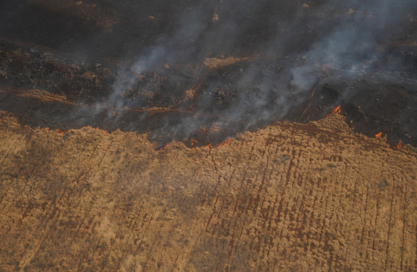  An aerial view of the fire as Two Hawaii Army National Guard CH47 Chinook (not pictured) perform aerial water bucket drops on the island of Maui to support the fight with wildfires in Maui, Hawaii, August 9, 2023. (photo credit: REUTERS)