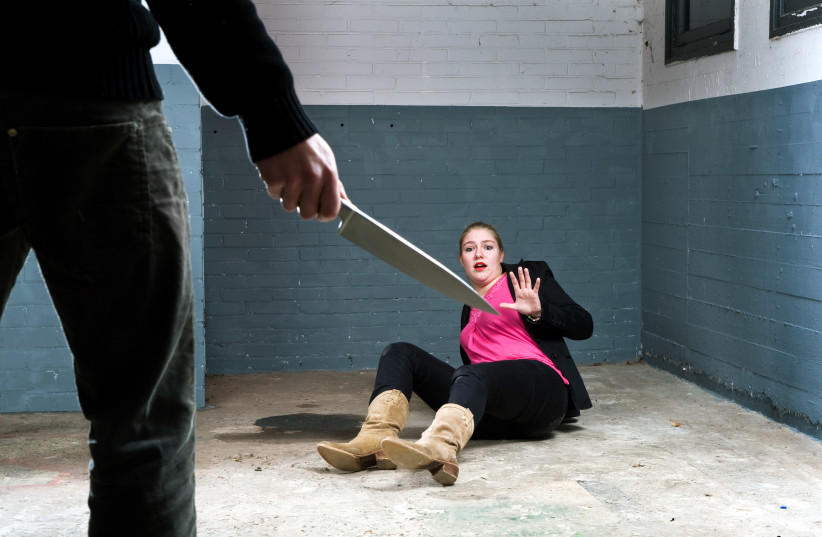  Murderer, holding a knife, face to face with a terrified woman in a basement (illustrative). (photo credit: INGIMAGE)