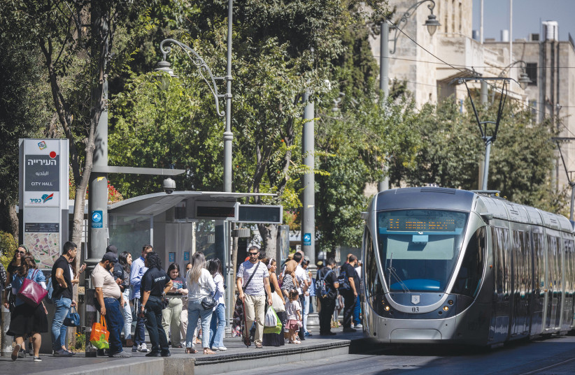  A LIGHT RAIL train stops at the Jerusalem City Hall station. ‘As a Jerusalemite since 1969, I have no desire to replace this chaotic pluralism for a largely monolithic secular, liberal, middle-class Ashkenazi Tel Avivian reality,’ says the writer. (photo credit: CHAIM GOLDBEG/FLASH90)