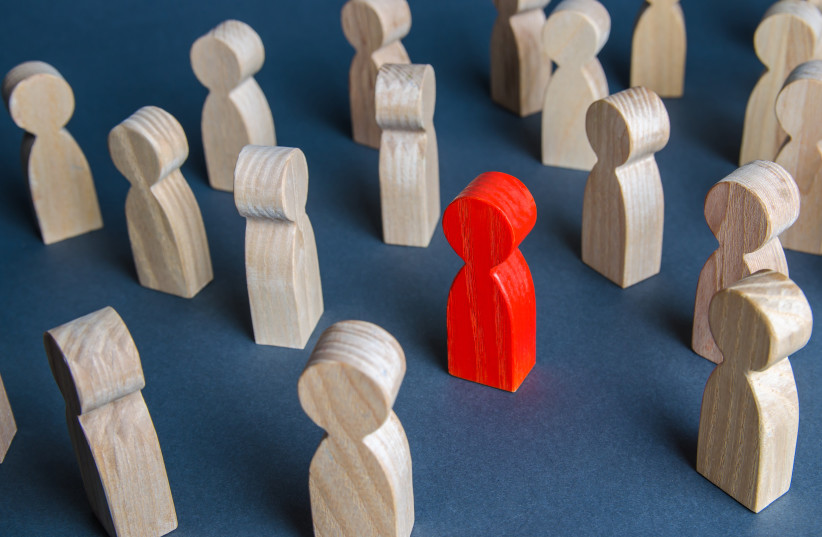  Red figurine of a man in a crowd of people (illustrative) (photo credit: INGIMAGE)