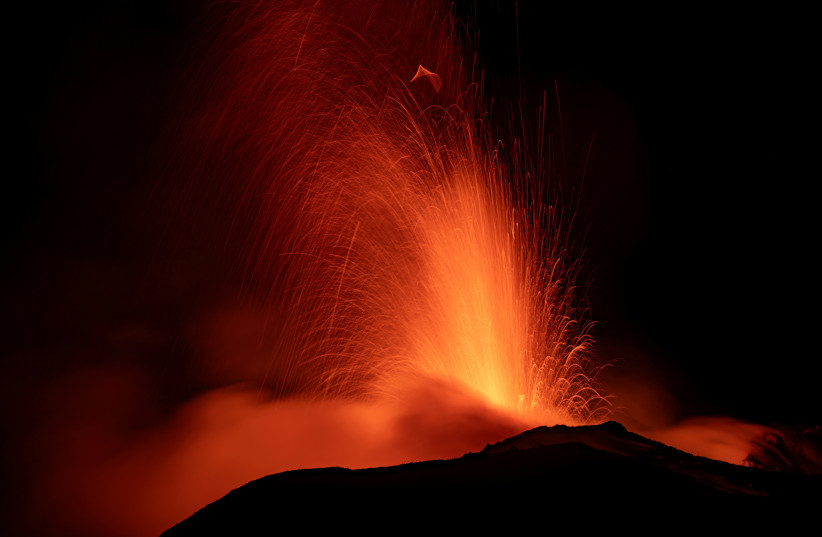  Mount Etna, Europe's most active volcano, lights up the night sky with eruptions as seen from Rocca Della Valle, Italy, August 13, 2023 (photo credit: REUTERS)