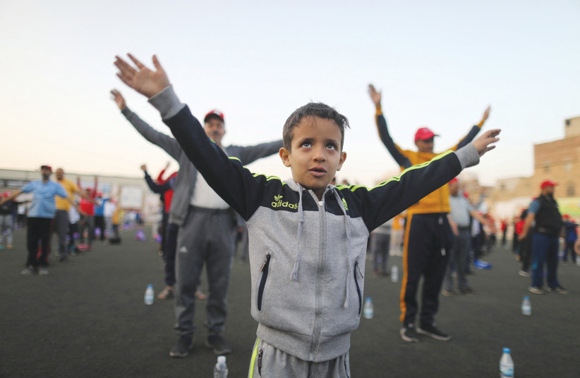  A BOY is among those participating in stretching exercises, as part of an initiative to help people cope with the stress of war, in Sanaa, last month.  (photo credit: KHALED ABDULLAH/REUTERS)