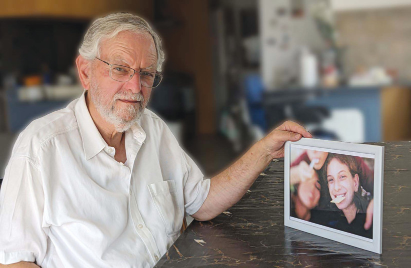  ARNOLD ROTH holds a photo of Malki and her friends at a picnic in Jerusalem’s Old City during the final year of his daughter’s life, a photo he developed from a disposable camera that he discovered after her death. (photo credit: Courtesy Arnold Roth)