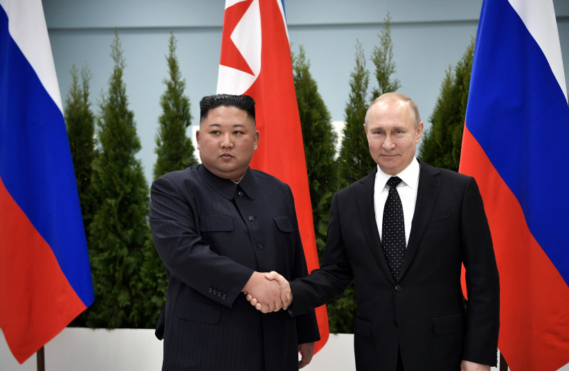  Kim Jong Un and Vladimir Putin shake hands. (photo credit: Wikimedia Commons)