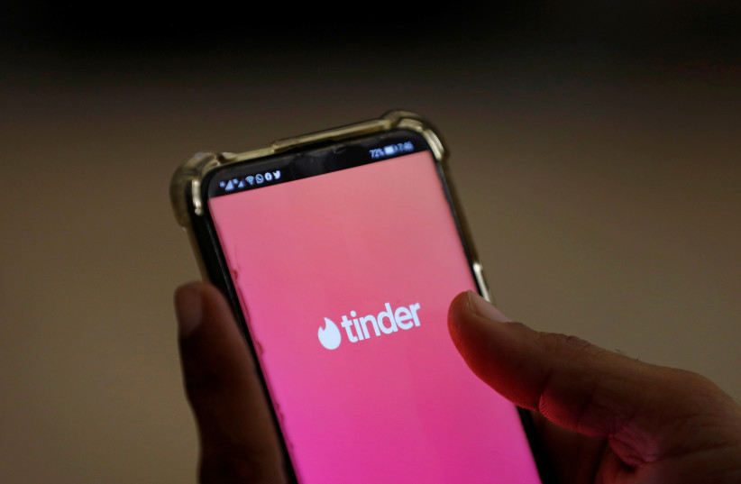  The dating app Tinder is shown on a mobile phone in this picture illustration taken September 1, 2020. Picture taken September 1, 2020. (photo credit: AKHTAR SOOMRO / REUTERS)