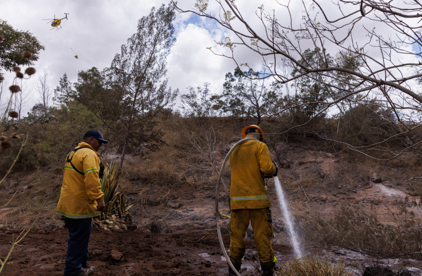  Maui County firefighters fight flare-up fires in a canyon in Kula on Maui island, Hawaii, US, August 13, 2023.  (photo credit: REUTERS/MIKE BLAKE)