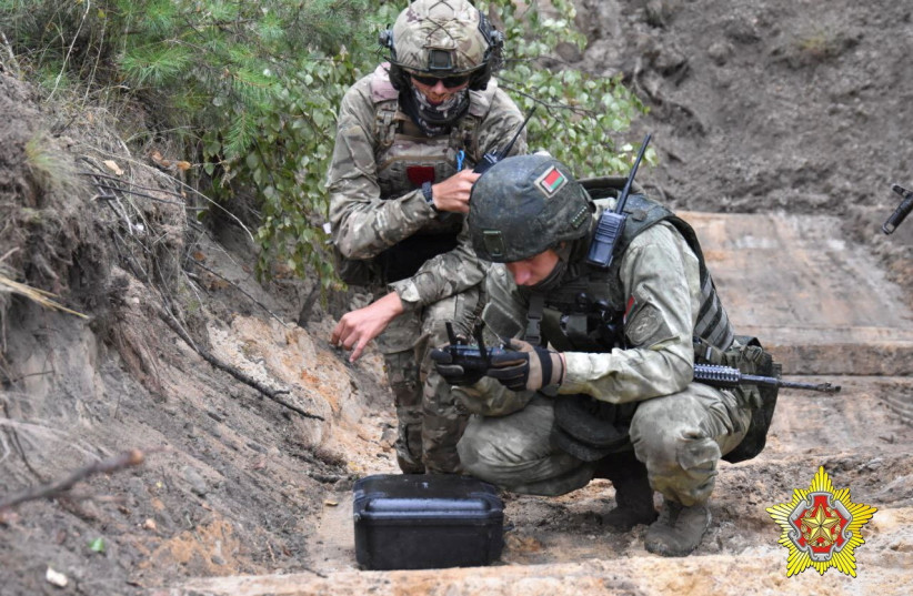  A fighter from Russian Wagner mercenary group and a Belarusian service member take part in a joint training at the Brest military range outside Brest, Belarus, in this still image released July 20, 2023. (photo credit: Belarusian Defense Ministry/Handout via REUTERS)