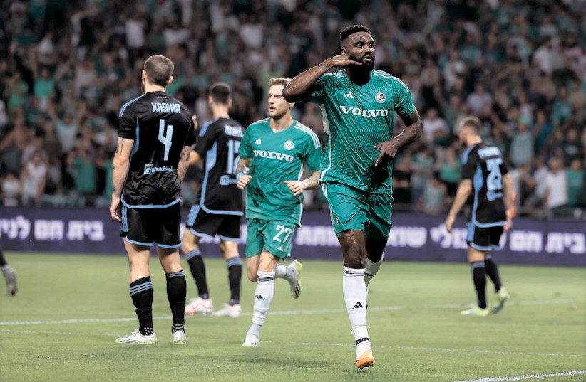  MACCABI HAIFA’S Frantzdy Pierrot (front) celebrates after scoring the Greens’ second goal in their 3-1 home victory over Slovan Bratislava to advance in Champions League qualifying. (photo credit: Maccabi Haifa/Courtesy)